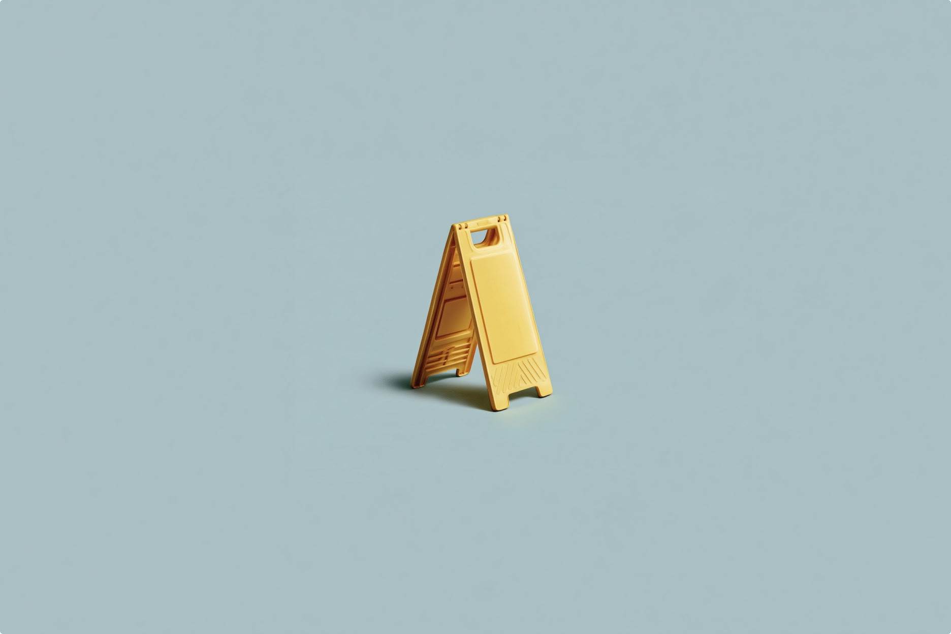 A blank yellow A-frame floor sign stands on a light blue surface.